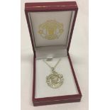 A Manchester United FC silver pendant on chain.