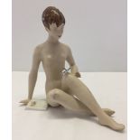 A Royal Dux bisque porcelain figurine of a nude woman.