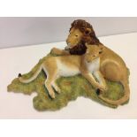 A retired Sherratt & Simpson resin figurine of 'Lion & Lioness lying down on grass'.