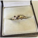 A pretty 9ct gold ladies dress ring set with 4 garnets.