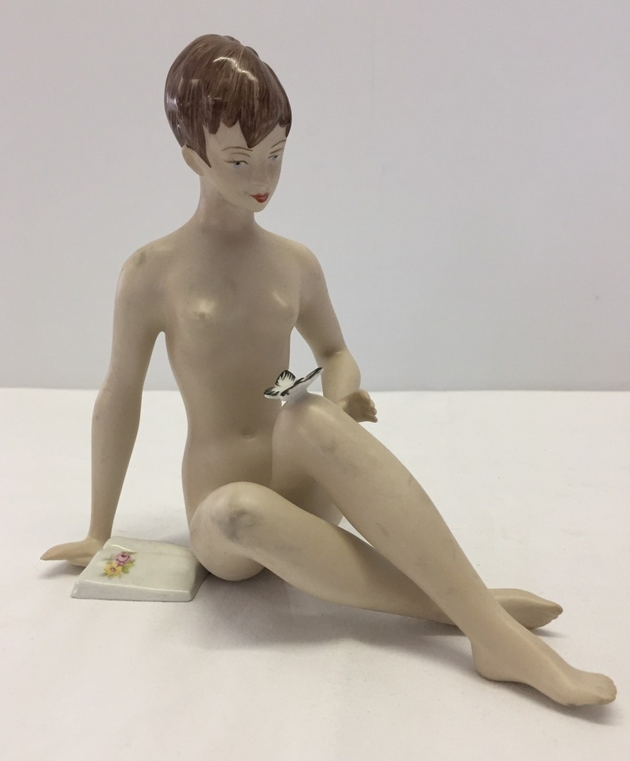A Royal Dux bisque porcelain figurine of a nude woman.