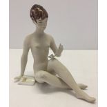 A Royal Dux bisque porcelain nude woman figurine.