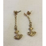 Gold anchor pendant earrings.