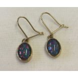 Gold earrings set with opals.