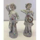 A pair of continental figurines of children playing with hoops.