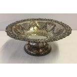An ornate silver plated fruit dish.