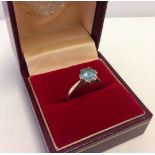 A 9ct gold dress ring set with large blue coloured stone.