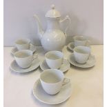 A Royal Copenhagen coffee pot with 6 cups & saucers. Half white lace pattern.