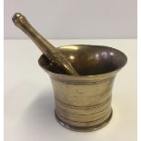 A vintage polished bronze pestle & mortar