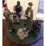 4 modern Action Man type soldiers on circular base with Action Man rifle-rack and rifles