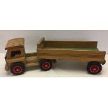 Large vintage wooden toy truck with detachable trailer. Measures approx 76cm long.