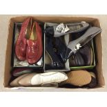 A box of vintage ladies shoes in autumnal colours.