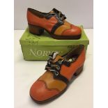 A boxed pair of vintage Norvis tie-up platform shoes.