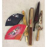 An assortment of vintage parasols and fans.