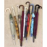 10 vintage ladies crook handled umbrellas with wooden, plastic and leatherette handled.