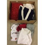 Box of new winter jumpers, dresses, trousers, tops and skirts.