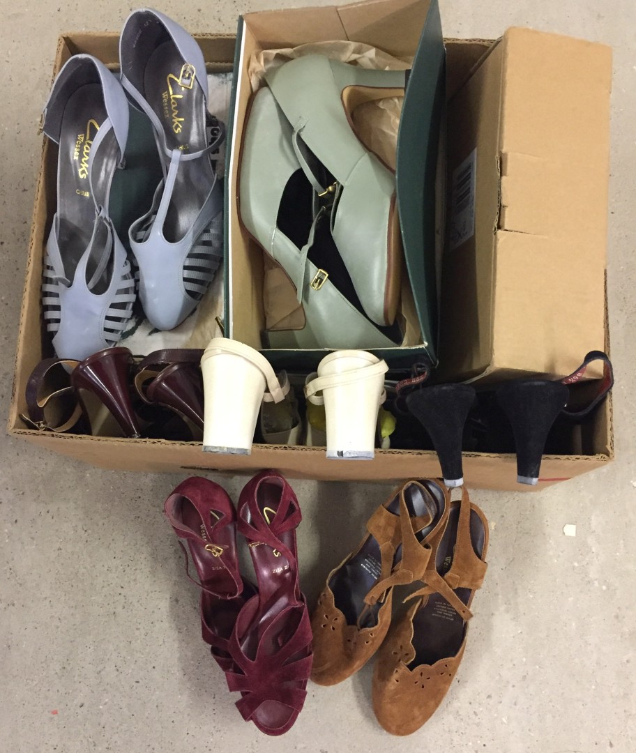 A box containing 12 pairs of vintage ladies Clarks shoes.