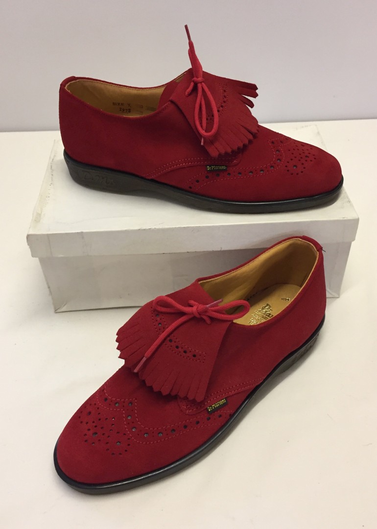 A boxed pair of vintage bright red suede Dr. Martens shoes.