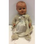 A vintage composition doll c.1950's. Needs re-stringing.