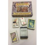 A small box containing vintage playing cards together with a vintage Royalty Jigsaw.