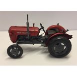 A reproduction tinplate Massey-Ferguson 5X tractor.