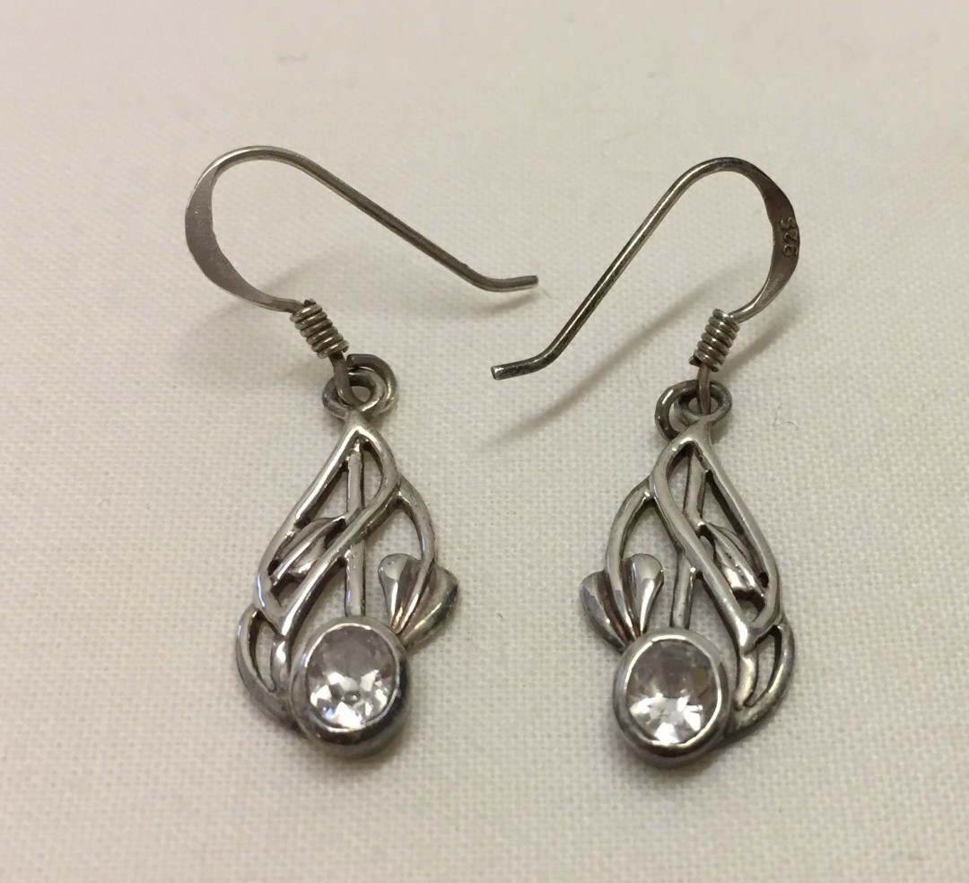 A pair of Art Nouveau design silver earrings set with crystals.