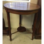 A circular occasional table with turned legs.