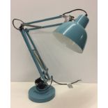 A modern blue angle poise lamp