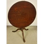 A mahogany tripod base tip top table with circular top.