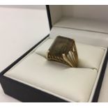 Large baguette cut smokey quartz dress ring mounted in a decorative split mount.