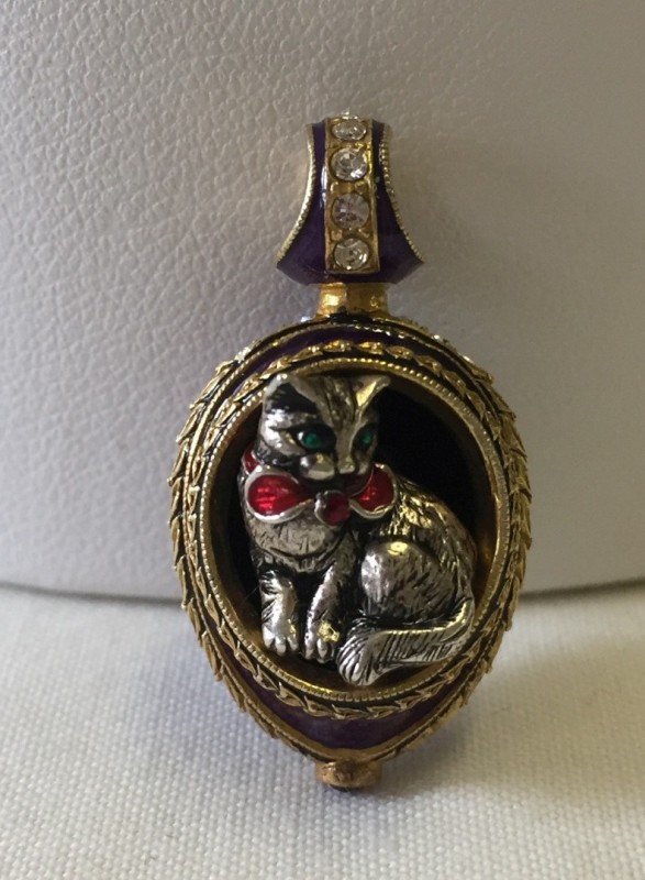 A silver gilt guilloche enamelled cat pendant.