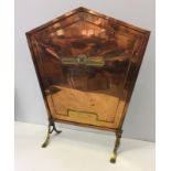 A vintage brass and copper fire screen.
