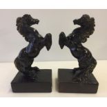 A pair of painted metal rearing horse figures.