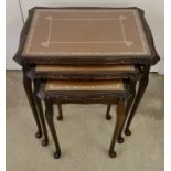 A nest of 3 leather and glass topped tables.