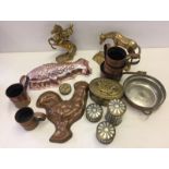 A box of mixed metalware to include brass and jelly moulds.