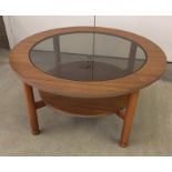 A circular wood & glass coffee table.