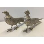 A pair of pewter pheasant figurines.