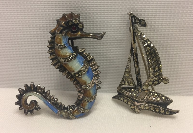 An enamel & marcasite seahorse brooch together with a marcasite yacht brooch