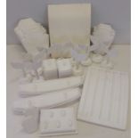 A box of white, leather effect jewellery display stands.
