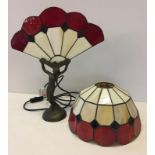 A reproduction Tiffany style naked lady lamp with fan-shape shade.