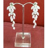A pair of long crystal drop earrings set in silver with silver posts.