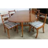 A drop leaf dining table with 4 matching chairs upholstered with blue stripe fabric.