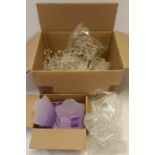 A box of clear, opaque and coloured plastic jewellery display stands.