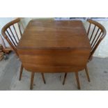 An Ercol drop leaf table and 2 chairs.