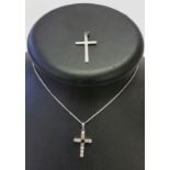 A silver cross set with crystals and garnet, on a silver chain. With a plain silver cross.