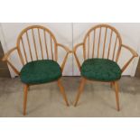 A pair of Ercol blonde stick back armchairs.