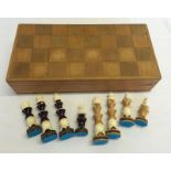A Mexican wooden chess set with bone and wood carved chess pieces.