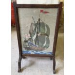 A glazed dark oak tapestry firescreen depicting a galleon.