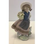 A Lladro figurine of a young flower girl signed by Lladro 1987. Model #5221 called Sweet Scent.