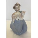 A boxed Lladro figurine of a young girl holding a cat.